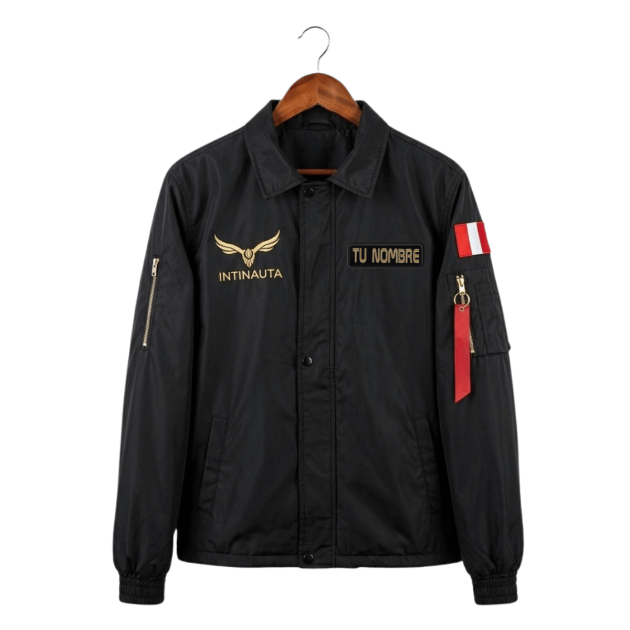 Black Intinauta coach jacket with gold logo, custom embroidered name patch, and Peruvian flag detail.
